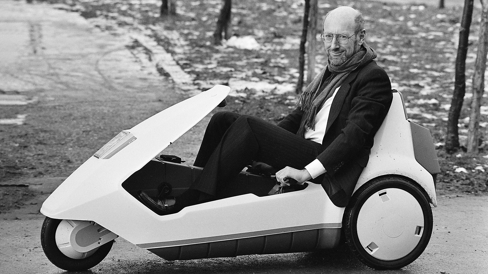 Sir Clive Sinclair sitting in his electric vehicle the C5